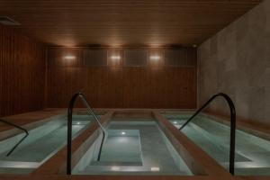 a swimming pool with stairs in a room at Wake Medellin, a Member of Design Hotels in Medellín