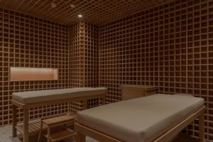 a room with a bench and a table in a brick wall at Wake Medellin, a Member of Design Hotels in Medellín