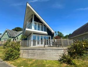 a house with a large deck with a balcony at Trewhiddle Retreat V30 by Together Travel - Luxury 4-Bedroom Villa in St Austell