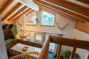 a room with a table and some antlers on the wall at Almhäuser Filzsteinalpe Almhaus 204 in Krimml