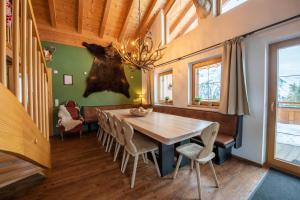 a dining room with a wooden table and chairs at Almhäuser Filzsteinalpe Almhaus 204 in Krimml +29 photos