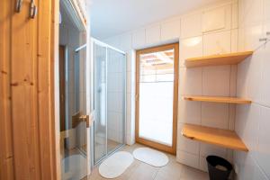 a bathroom with a shower and a glass door at Almhäuser Filzsteinalpe Almhaus 204 in Krimml