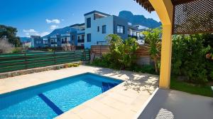 a swimming pool in front of a house at Villa Peri Luxury Pool Villa in Karşıyaka in Nicosia