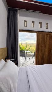 a bedroom with a bed and a view of a table at Payas Private Farm Villa in Praya