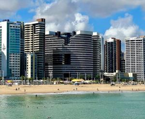 a beach in front of a city with tall buildings at Landscape Beira Mar - Lindo, Luxo, Frente mar in Fortaleza