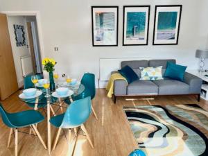 a living room with a couch and a table and chairs at Between the Beach and Shops 2 bath private parking in Portsmouth