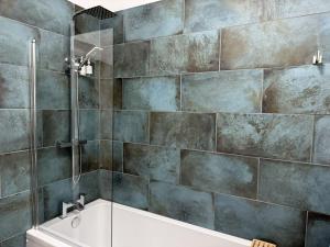 a bathroom with a shower and a bath tub at Between the Beach and Shops 2 bath private parking in Portsmouth +26 photos