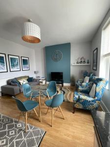 a living room with a couch and a table and chairs at Between the Beach and Shops 2 bath private parking in Portsmouth