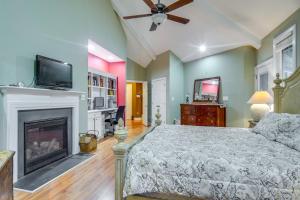 a bedroom with a bed and a fireplace at Spacious Lakefront in Fayetteville