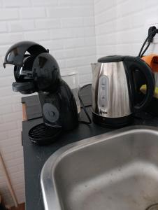 a toaster sitting on a counter next to a sink at Cozy 5 in Belgrade