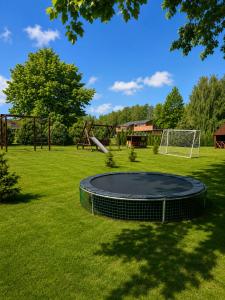 a trampoline in the middle of a park at Marių įlanka camping in Marijampolė