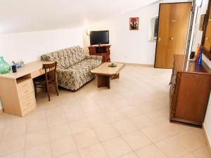 a living room with a couch and a table at MANSARDA COSTA BIANCA - Free Parking in Realmonte