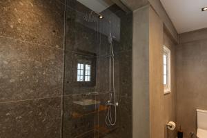 a bathroom with a shower with a glass door at Olive Grove Apartments in Larnaca +63 photos