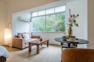 a living room with a couch and a table at Green Emerald in Haifa
