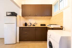 a kitchen with a white refrigerator and a washing machine at Green Emerald in Haifa