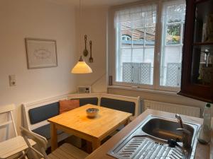 a kitchen with a table and a sink and a table at Ferienwohnung Am Mittelburgwall in Friedrichstadt