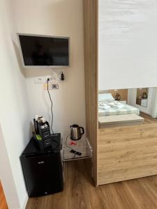 a room with a bed and a television on a wall at Il Ligustro by Roberto in San Giovanni Lupatoto +13 photos