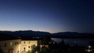 a view of a lake at night with a building at Ulëz Nature Apartment in Ulëz
