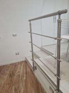 a metal shelf in a room with a wooden floor at Horizon Suite Bellavista in Catanzaro
