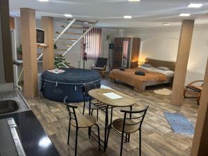 a living room with a bed and a table and chairs at Gesztenyés Apartman Mátra Wellness in Parád
