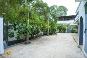 a courtyard with palm trees and a building at Hidden Heaven Villa in Puducherry Airpoert