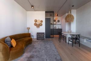 a living room with a couch and a table at Suite O in Ostend
