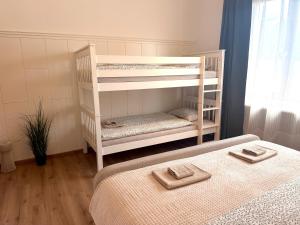 a white bunk bed with two sets of towels on it at Apartments Chloe - Top 5 in Hollabrunn