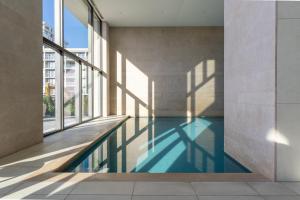a swimming pool in the middle of a building at Suite O in Ostend
