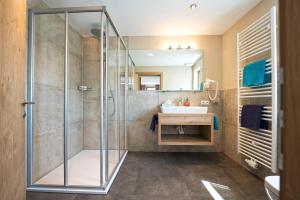 a bathroom with a shower and a sink at Haus Alpenrose in Serfaus +14 photos