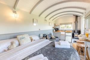a bedroom with a large bed and a kitchen at 1 Bed in Beaworthy oc-93267 in Ashwater