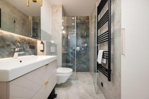 a bathroom with a sink and a toilet and a shower at Golf Park Rajszew in Rajszew +67 photos