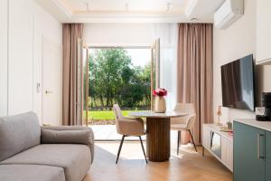 a living room with a couch and a table at Golf Park Rajszew in Rajszew
