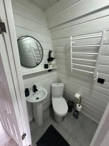 a small bathroom with a toilet and a sink at Black Pepper in Yaremche +13 photos