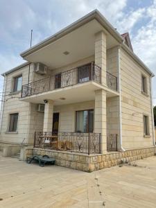a large house with a balcony on the front of it at JB Dubendi house in Baku