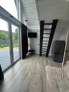 a large living room with wooden floors and large windows at Black Pepper in Yaremche