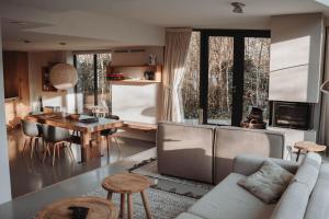 a living room with a couch and a table at Dutchen Park Duynzoom in De Koog