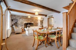 a dining room with a table and a fireplace at 2 Bed in Llangynidr oc-l31914 in Llangynidr