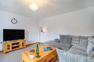 a living room with a couch and a tv at 2 Bed in Llangynidr oc-l31914 in Llangynidr