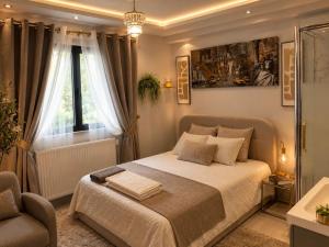 a bedroom with a bed and a chair and a window at Elegancia del JJM in Annemasse