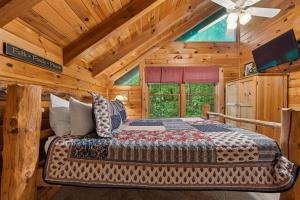 a bedroom with a bed in a log cabin at A Rustic Elegance #4 by Venture Smoky Mountains in Sevierville