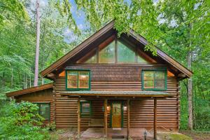 a log cabin in the woods with trees at A Rustic Elegance #4 by Venture Smoky Mountains in Sevierville