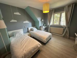 a bedroom with two beds and a window at Spacieuse et agréable à séjourner in Garges-lès-Gonesse