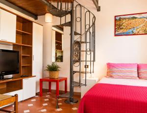 a bedroom with a bed with a red bedspread at Max Studios Florence in Florence