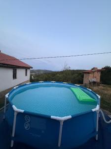 a large blue swimming pool in a yard at Kod Svastike in Džepare