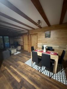 a dining room with a table and chairs at Kod Svastike in Džepare