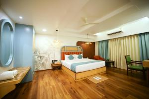 a bedroom with a bed and a table and a chair at Surya Garden in Tālcher