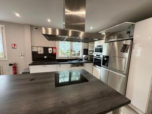 a kitchen with stainless steel appliances and a wooden counter top at Spacieuse et agréable à séjourner in Garges-lès-Gonesse