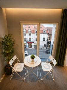 a table and two chairs in a room with a window at Boutique Hotel Bora in Peje