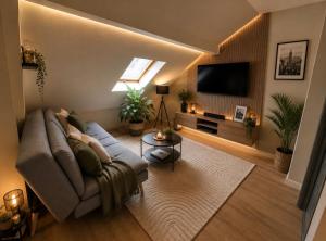 a living room with a couch and a flat screen tv at Elegancia del JJM in Annemasse