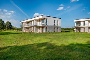 a large grass field in front of a house at Golf Park Rajszew in Rajszew